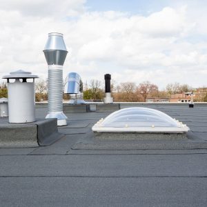 58534428 - inox chimney on the flat roof in the city